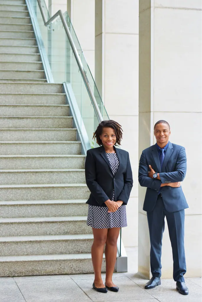 Two G&A advocates standing by an office staircase